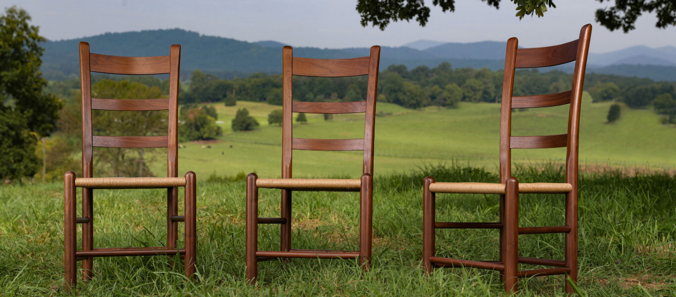 Three Clore chairs sitting on a hill