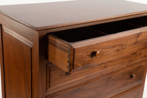 Close-in view of chest of drawers with raised panels