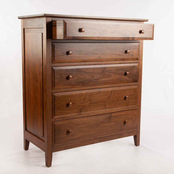 Solid wood chest of drawers with raised panels, top drawer open